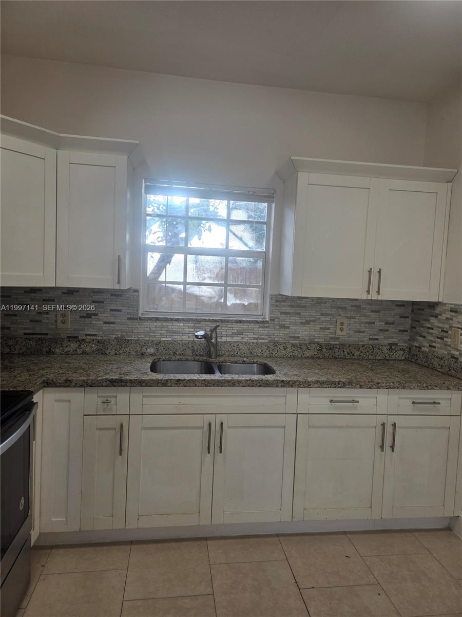 9740 Northwest 5th Avenue Miami, FL 33150 - Photo 5 of 18 a kitchen with white cabinets