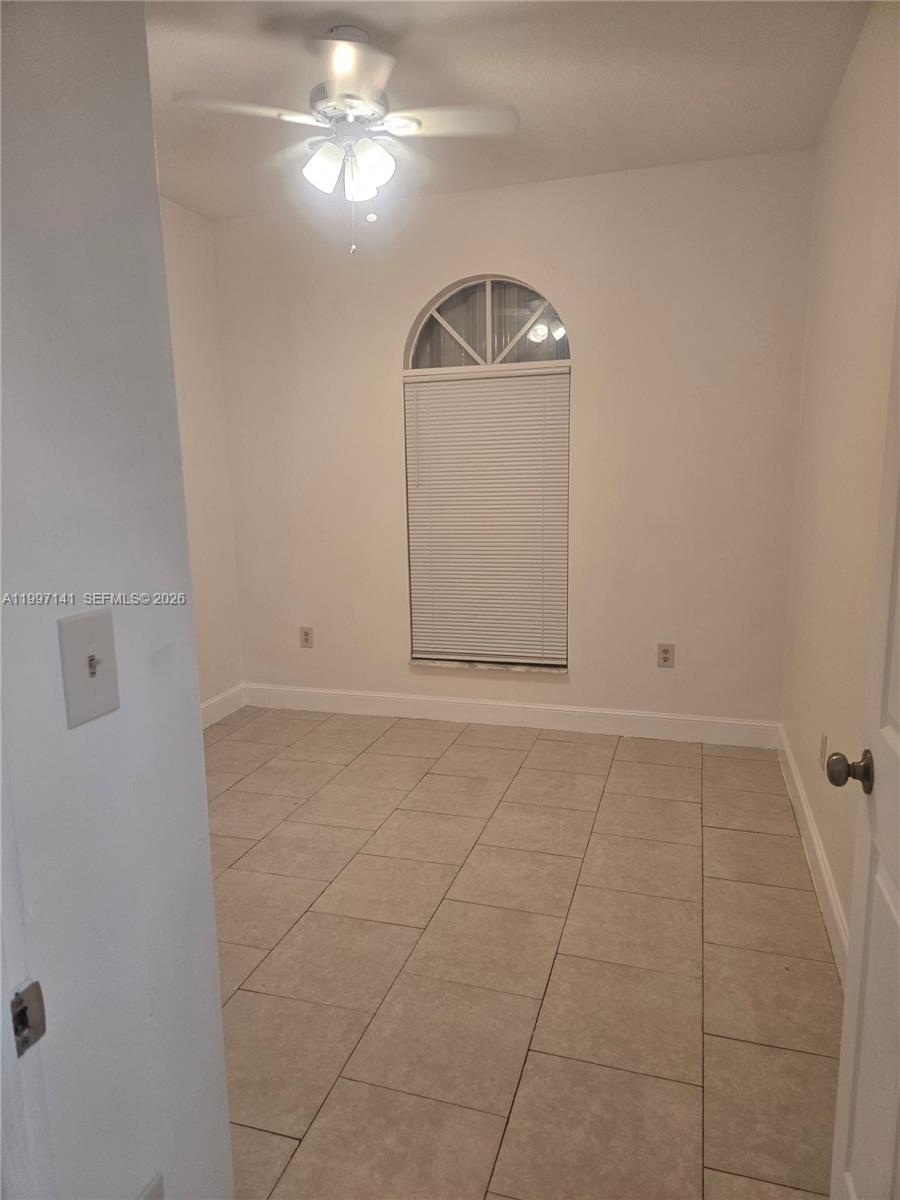 9740 Northwest 5th Avenue Miami, FL 33150 - Photo 9 of 18 a view of an empty room with a window