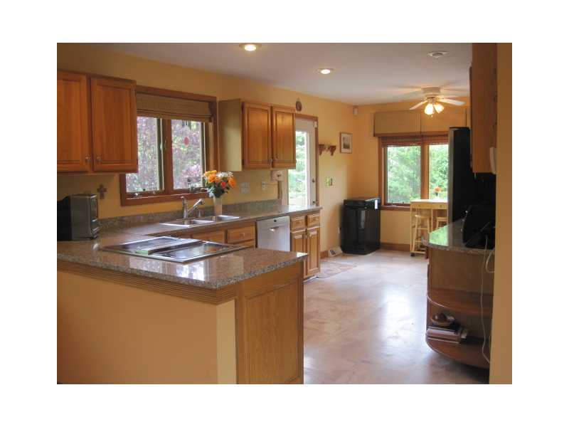 46 Rhodes Street Cumberland, RI 02864 - Photo 13 of 25 Kitchen. Large eat in kitchen that is open to the formal dining room area. Granite counters and a stainless steel fridge and dishwasher.