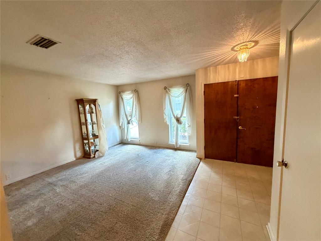 2030 Sycamore Street Paris, TX 75460 - Photo 2 of 24 Entryway featuring a double-door entrance with decorative hardware, an ornate ceiling light fixture, and tile flooring