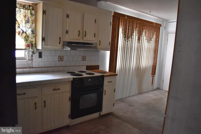 a kitchen with a refrigerator sink and stove