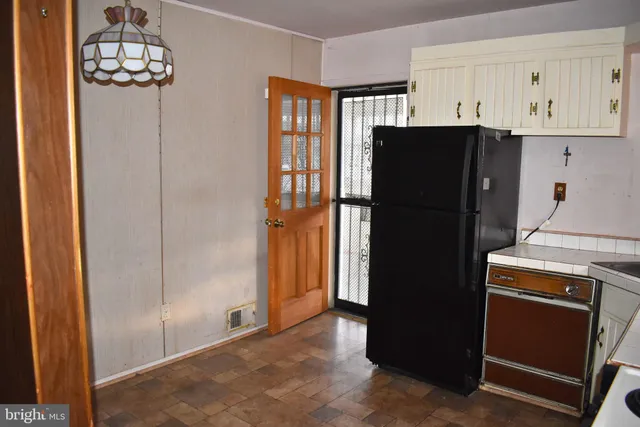 a view of a balcony with chairs and iron stairs