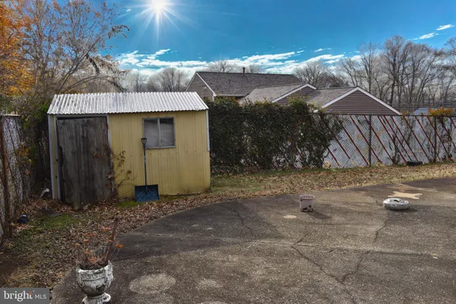 a view of patio with a table and chairs under an umbrella