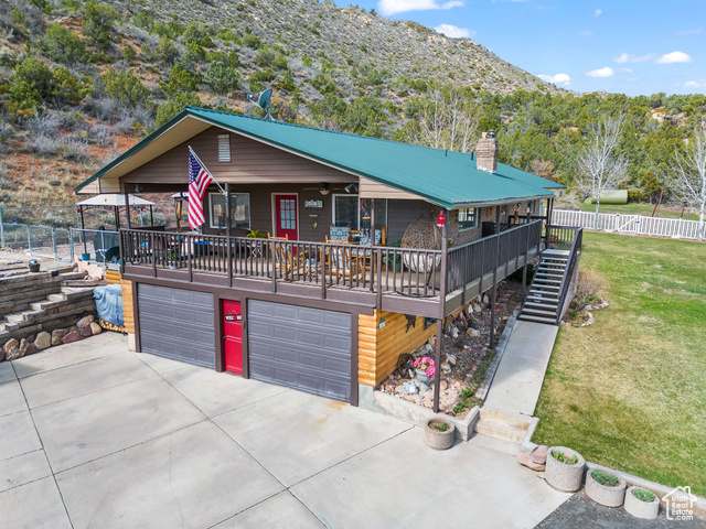 6407 North Dry Frk Cyn Road West Vernal, UT 84078 - Photo 5 of 48 View of front facade with a garage, concrete driveway, a mountain view, stairway, and metal roof