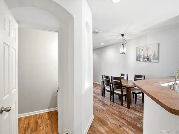 a view of a dining room with furniture and wooden floor