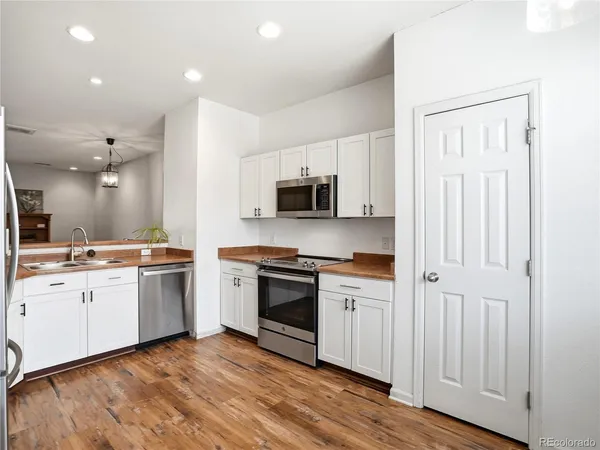 a kitchen with a stove top oven and sink