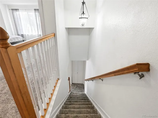 a spacious bedroom with a bed and a chandelier