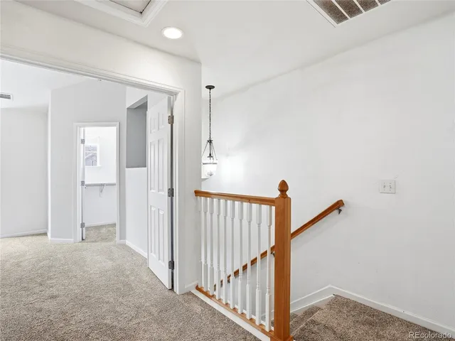 a spacious bedroom with a bed window and couch