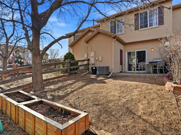 an aerial view of residential houses with outdoor space and parking
