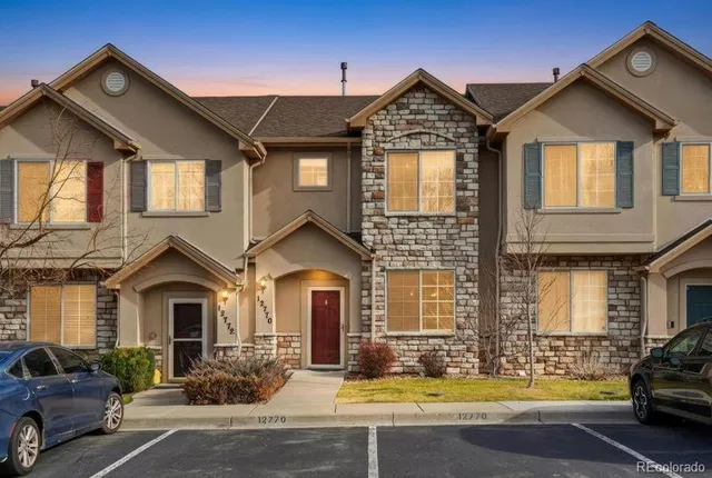 an aerial view of a house with swimming pool and a yard