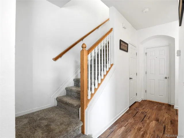a view of entryway with wooden floor and stairs