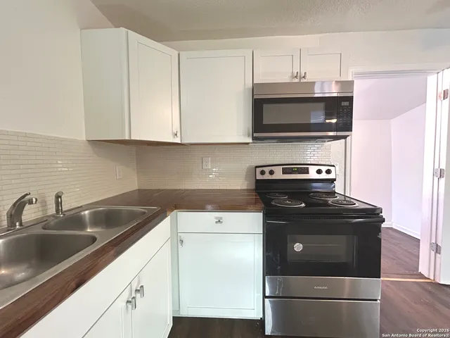 a kitchen with a sink and a stove