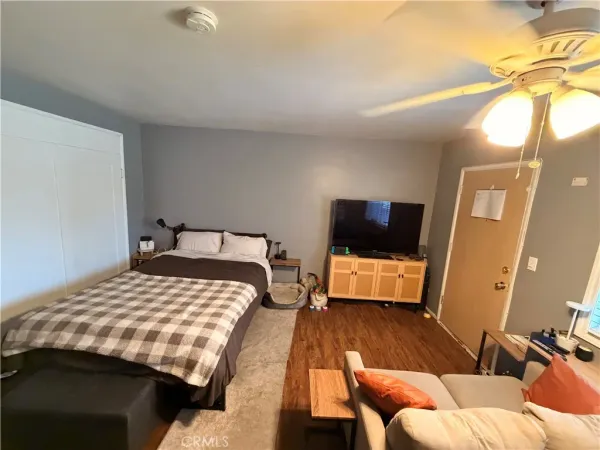 a bedroom with a bed and flat screen tv