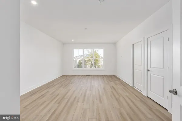 a view of a kitchen with a sink and wooden floor