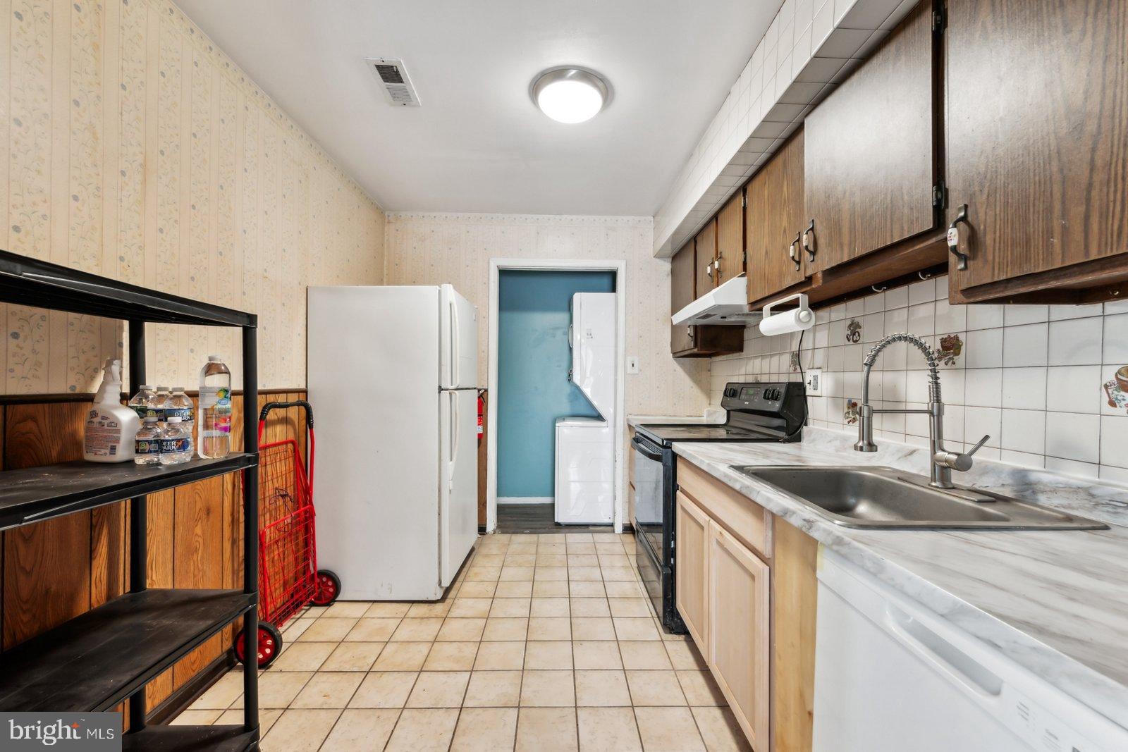 1004 Timber Creek Road Clementon, NJ 08021 - Photo 2 of 24 a kitchen with stainless steel appliances granite countertop a sink stove and refrigerator