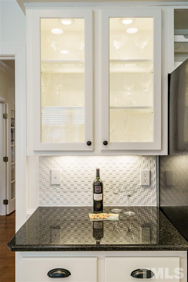 8509 Riddle Place Raleigh, NC 27615 - Photo 11 of 30 a kitchen with granite countertop a sink and a window