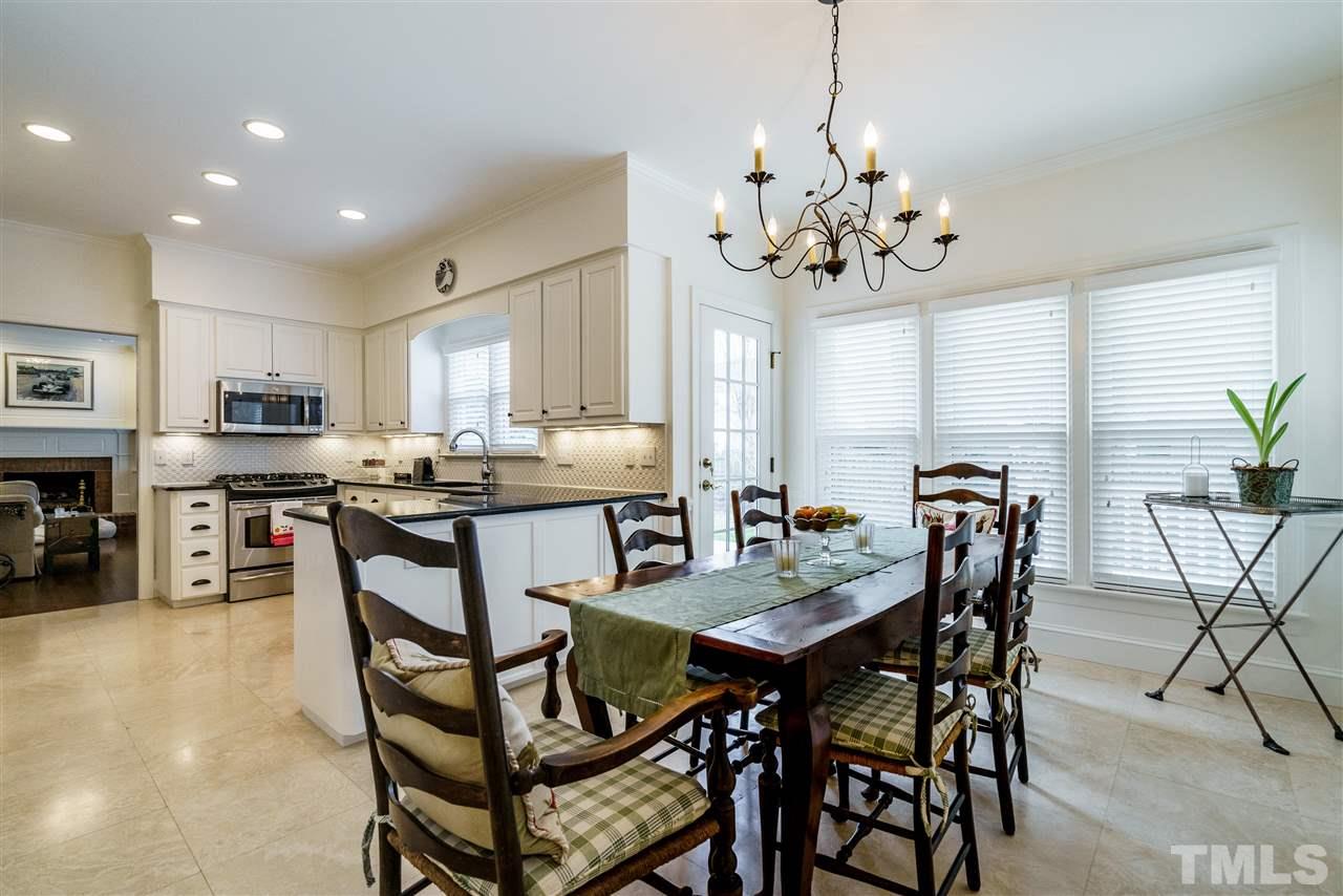 8509 Riddle Place Raleigh, NC 27615 - Photo 12 of 30 a view of a dining room with furniture and a chandelier