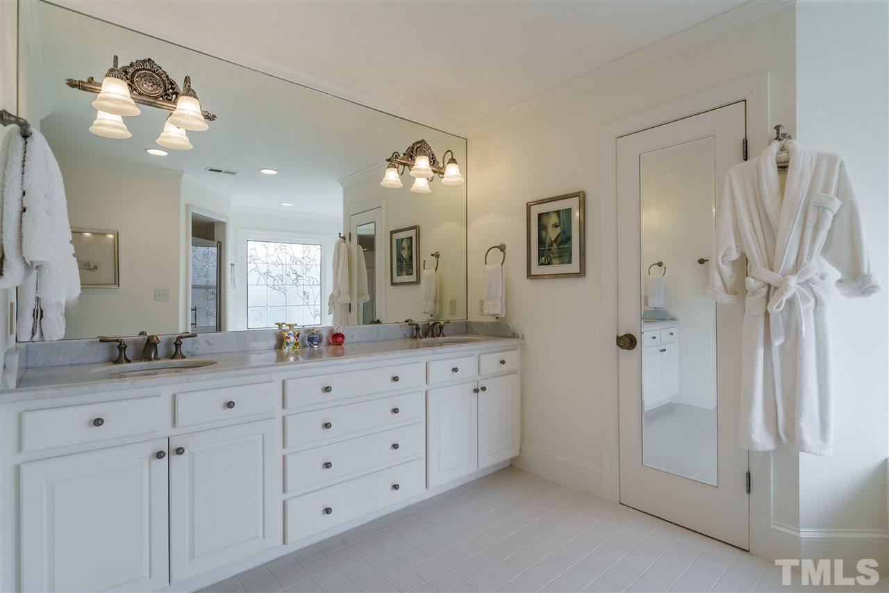 8509 Riddle Place Raleigh, NC 27615 - Photo 19 of 30 a bathroom with a double vanity sink mirror and double