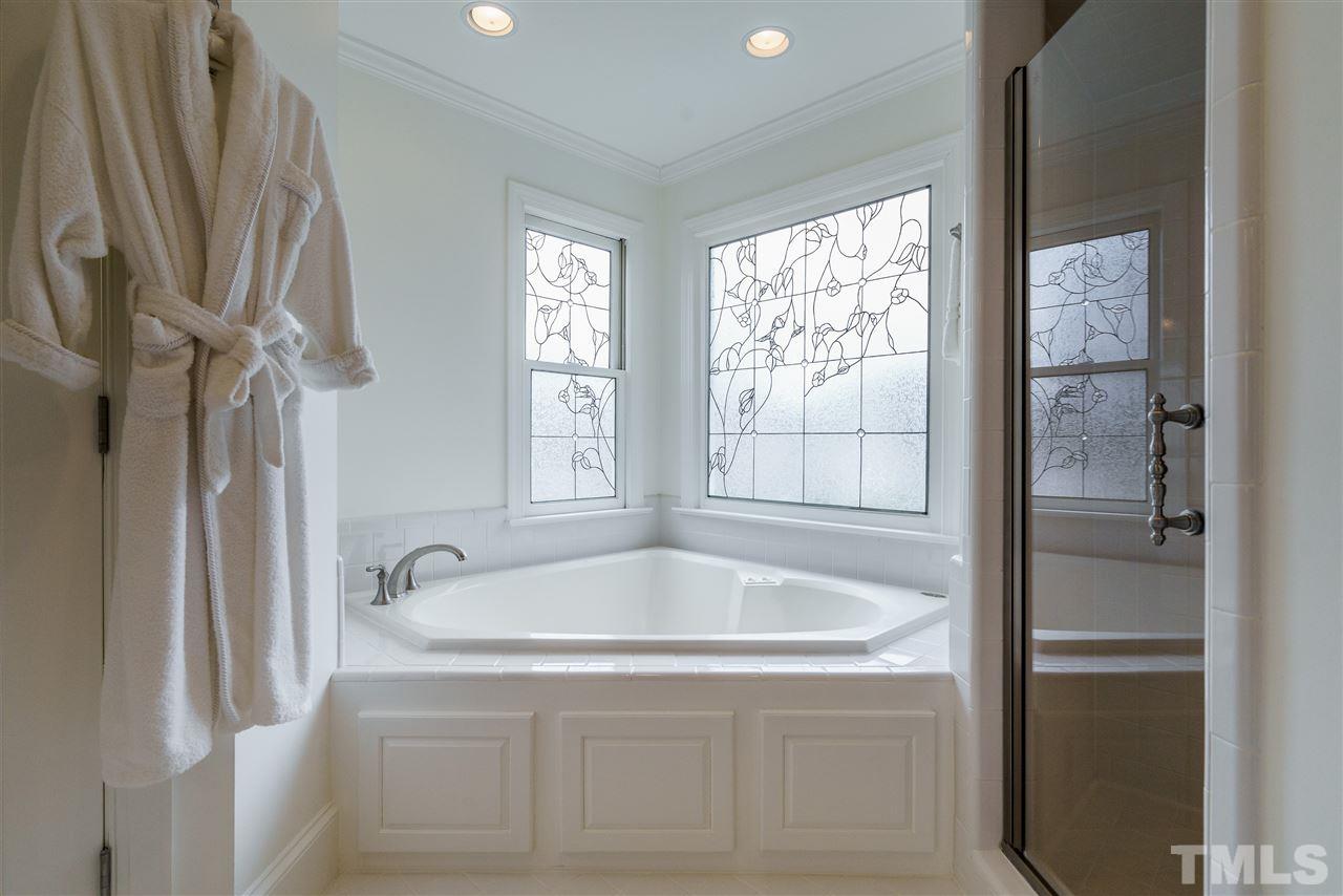 8509 Riddle Place Raleigh, NC 27615 - Photo 23 of 30 a bath tub sitting next to a window