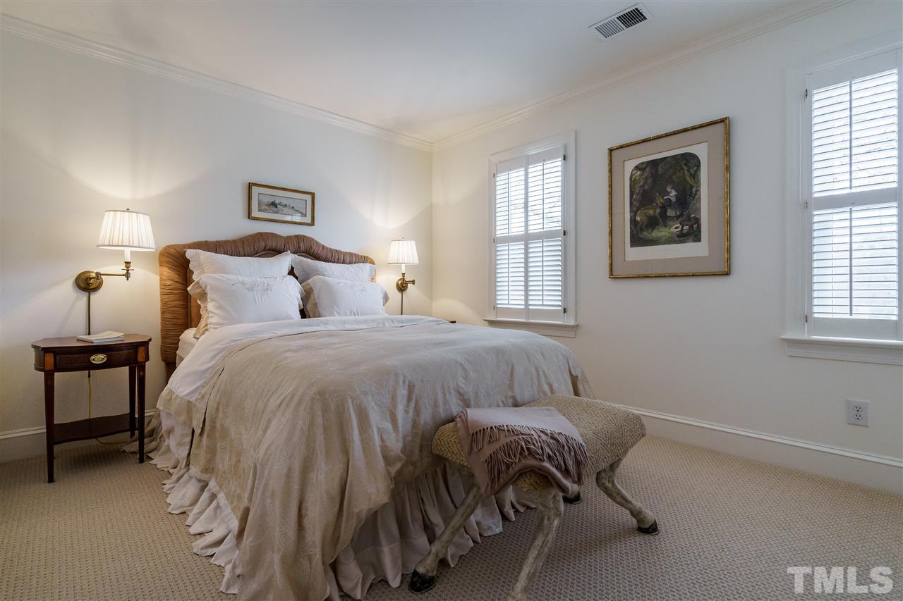 8509 Riddle Place Raleigh, NC 27615 - Photo 24 of 30 a bedroom with a bed and a window