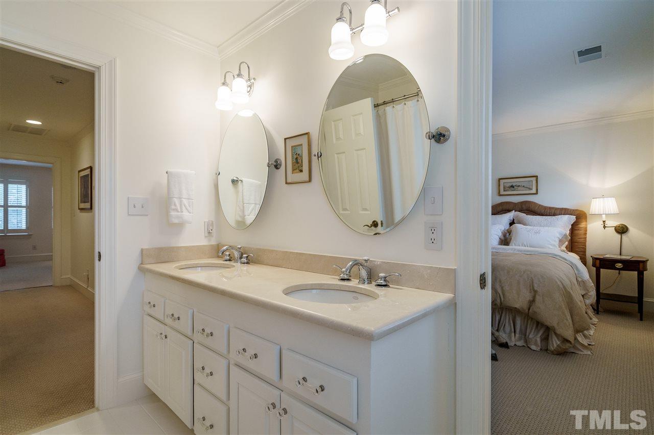 8509 Riddle Place Raleigh, NC 27615 - Photo 25 of 30 a en suite bathroom with a double vanity sink and a mirror