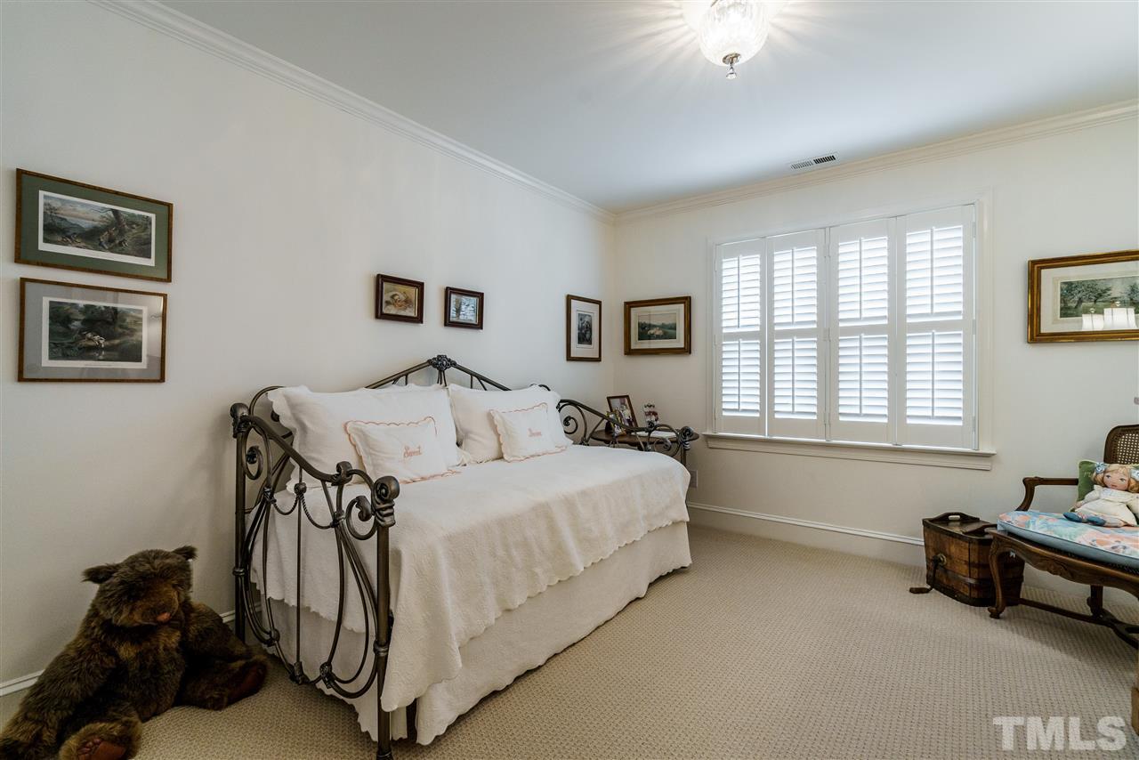 8509 Riddle Place Raleigh, NC 27615 - Photo 26 of 30 a bedroom with a bed and a couch