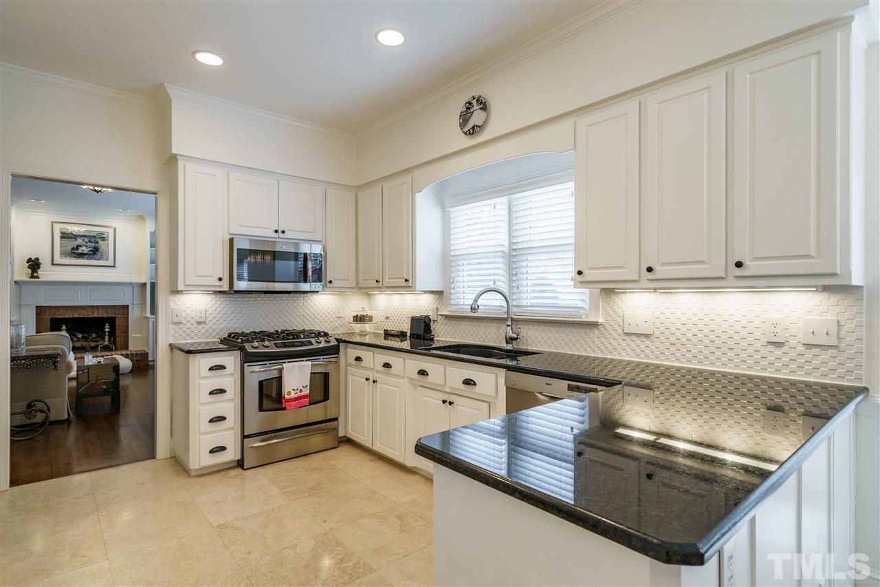 8509 Riddle Place Raleigh, NC 27615 - Photo 7 of 30 a kitchen with stainless steel appliances granite countertop a sink dishwasher stove and refrigerator