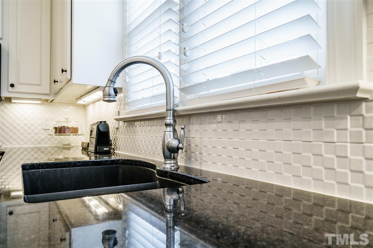 8509 Riddle Place Raleigh, NC 27615 - Photo 9 of 30 a kitchen with a sink and a stove