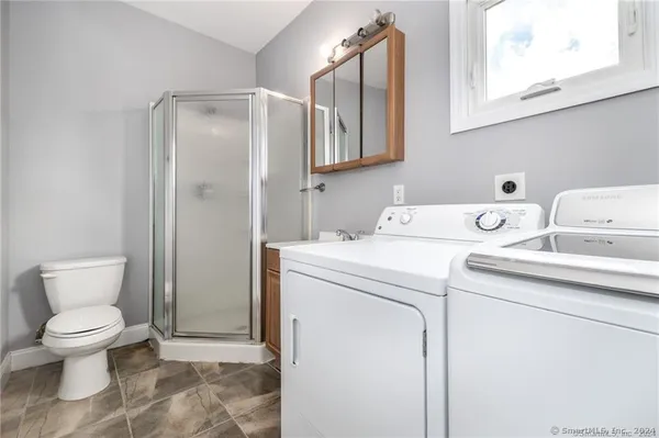 a bathroom with a sink toilet and shower