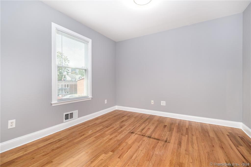 29 Dolsen Place, Unit 2 Stamford, CT 06901 - Photo 12 of 18 wooden floor in an empty room with a window