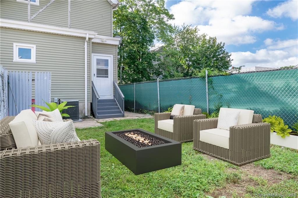 29 Dolsen Place, Unit 2 Stamford, CT 06901 - Photo 16 of 18 a view of a house with backyard and sitting area