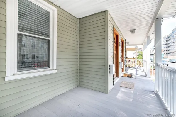 a view of a porch with a floor to ceiling window