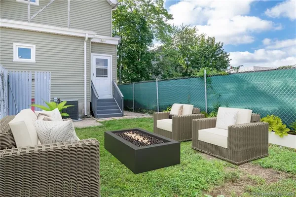 a view of a house with backyard and sitting area