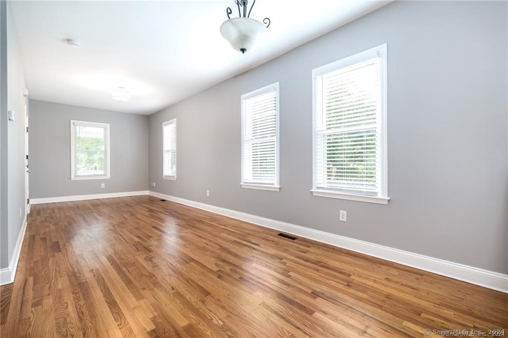 29 Dolsen Place, Unit 2 Stamford, CT 06901 - Photo 3 of 18 a view of empty room with wooden floor and fan