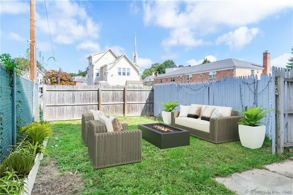 a view of a patio with couches chairs and a potted plant