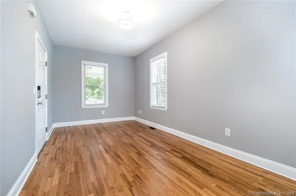 wooden floor in an empty room with a window