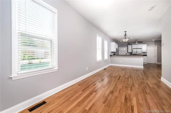 a view of a kitchen with wooden floor and windows