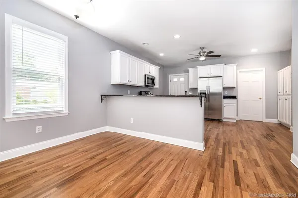 a view of a kitchen with wooden floor and a kitchen