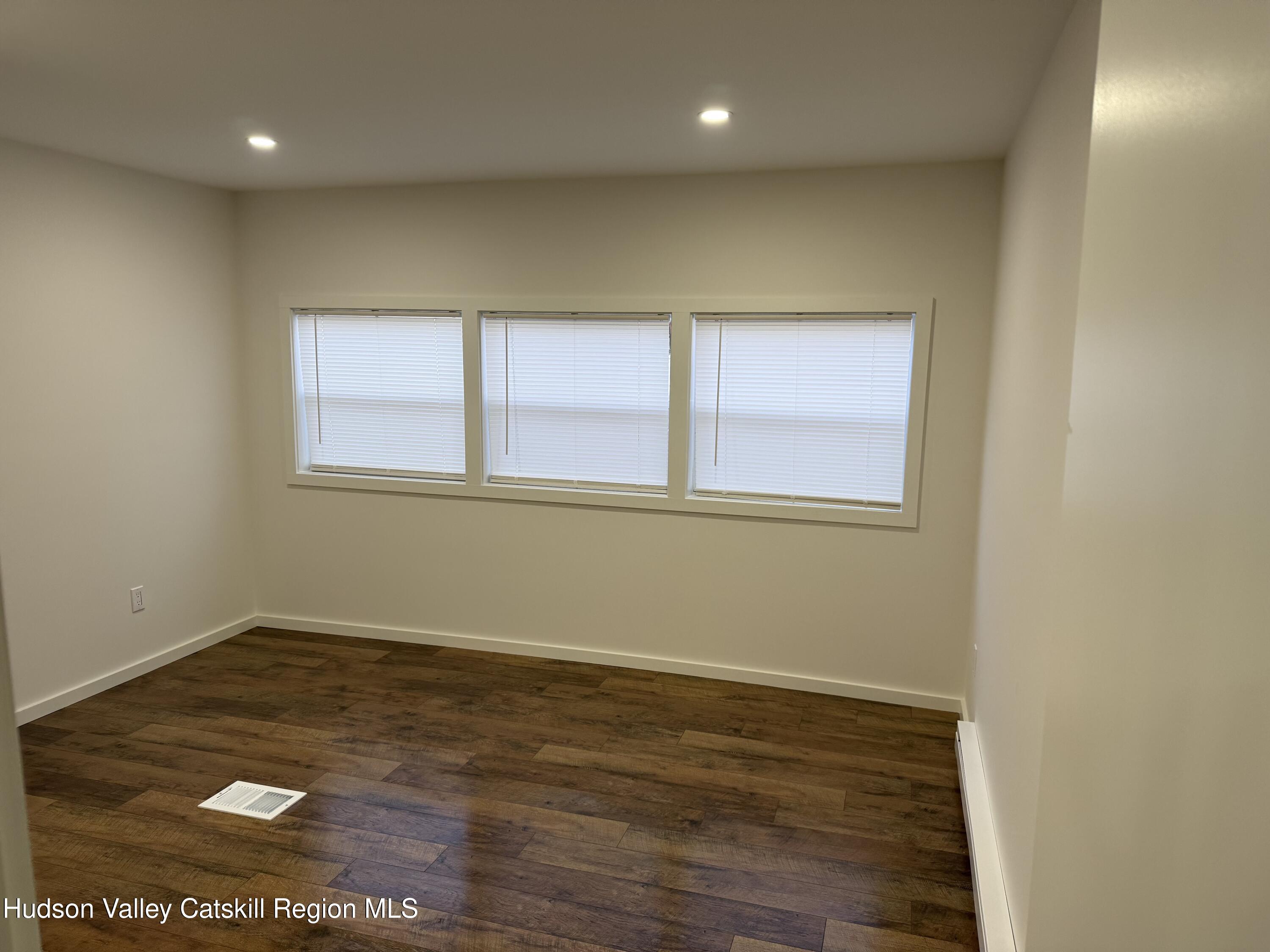 31 Bell Way Monticello, NY 12701 - Photo 11 of 15 an empty room with wooden floor and windows
