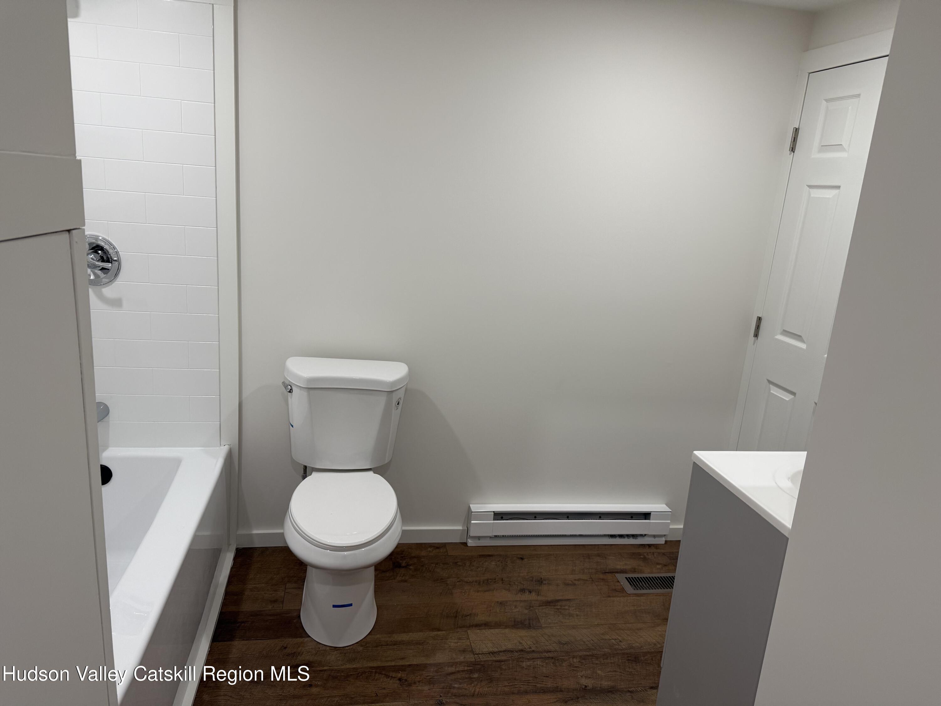 31 Bell Way Monticello, NY 12701 - Photo 14 of 15 a white toilet sitting in a bathroom next to a sink