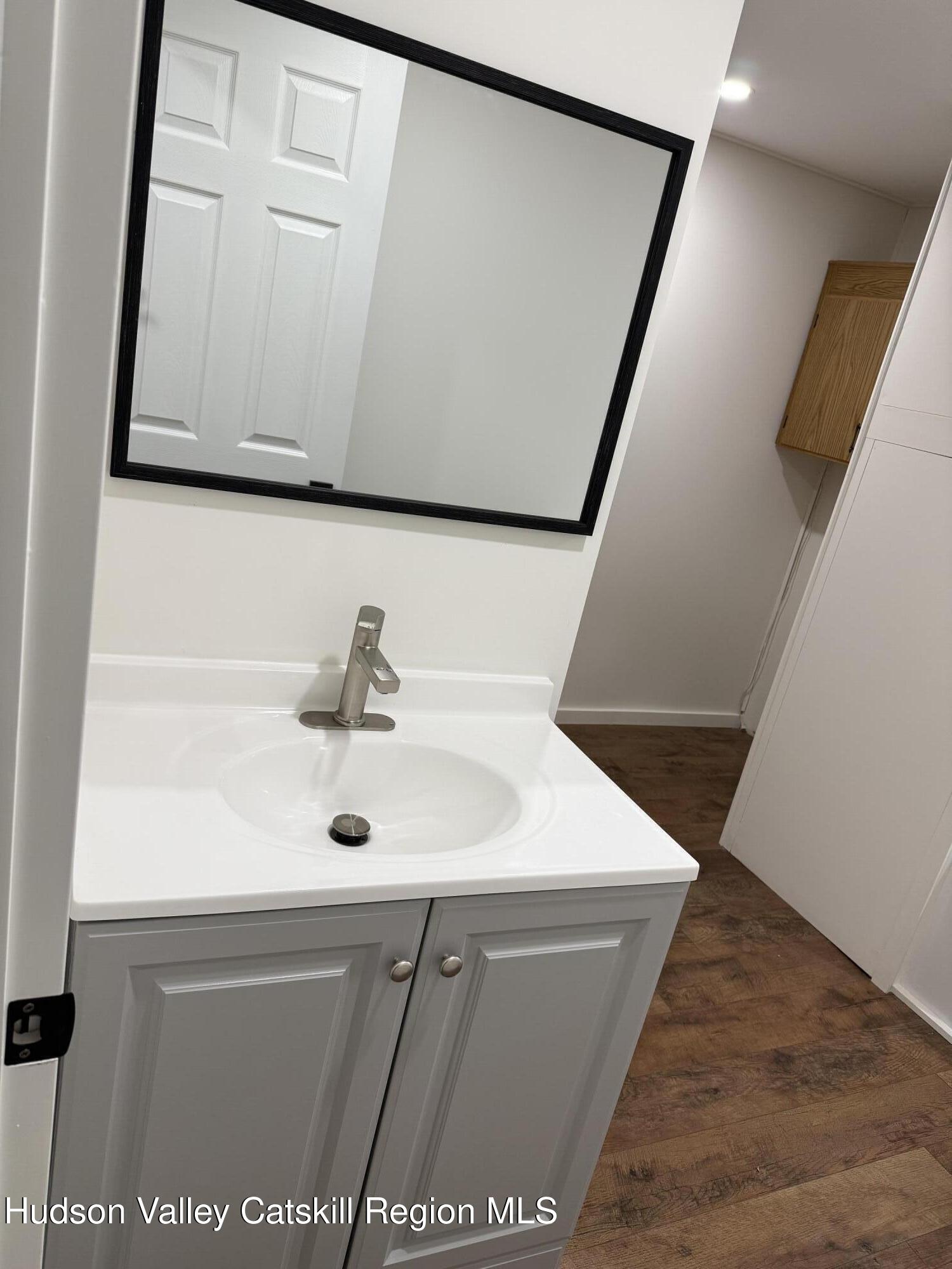 31 Bell Way Monticello, NY 12701 - Photo 15 of 15 a bathroom with a sink and a mirror