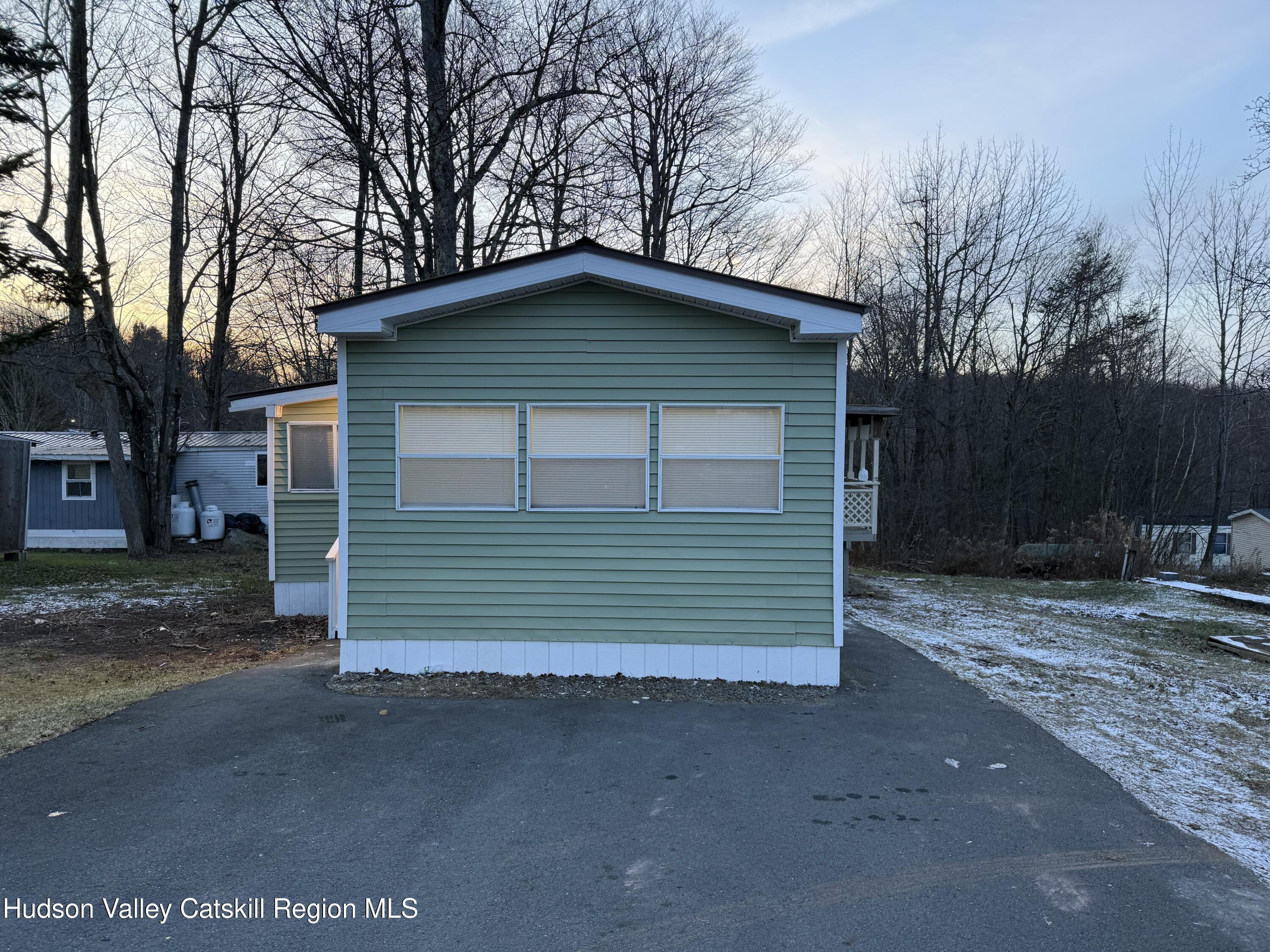 31 Bell Way Monticello, NY 12701 - Photo 3 of 15 a front view of a house with a yard and garage