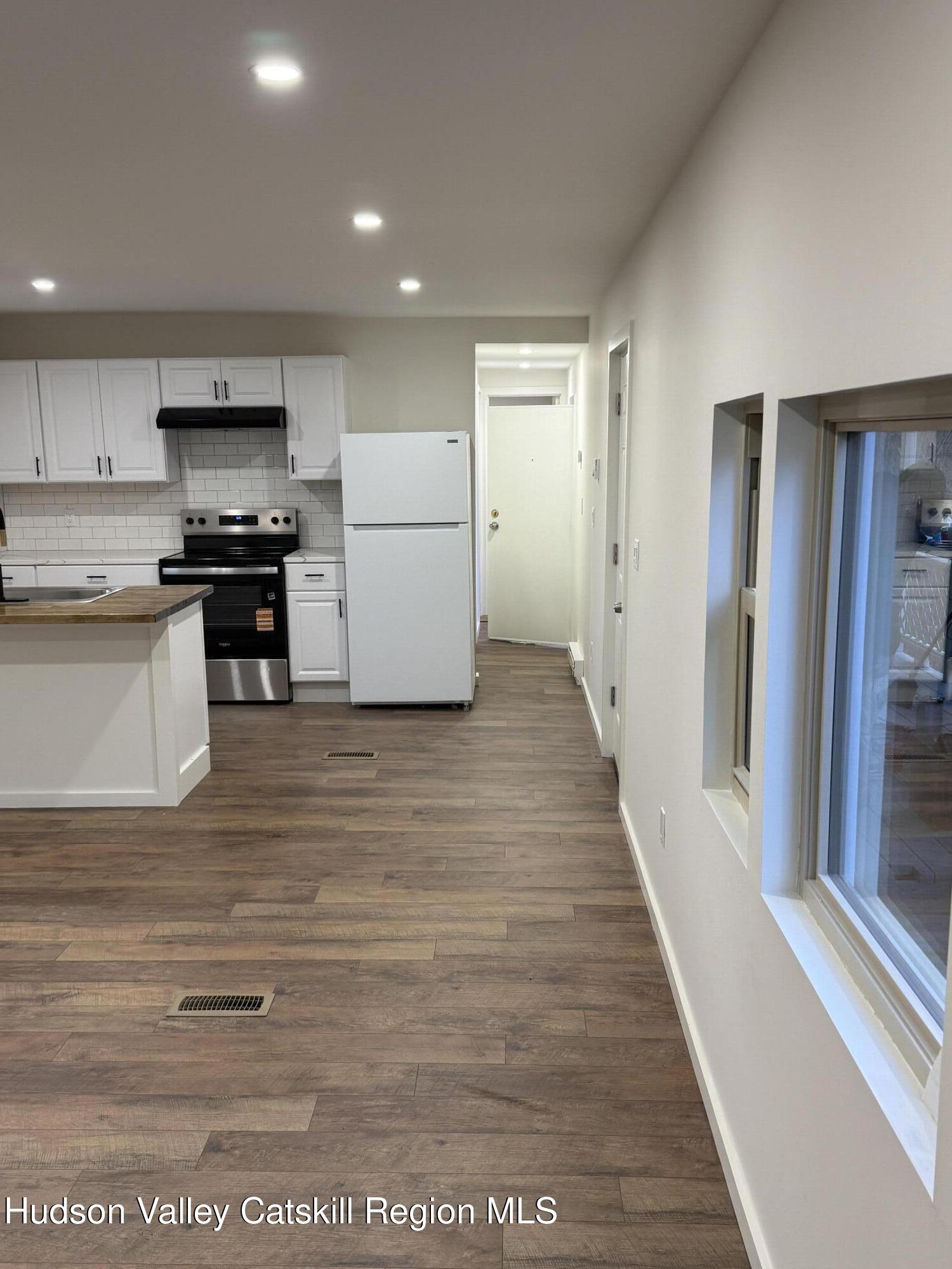 31 Bell Way Monticello, NY 12701 - Photo 5 of 15 a kitchen with a refrigerator and a stove top oven