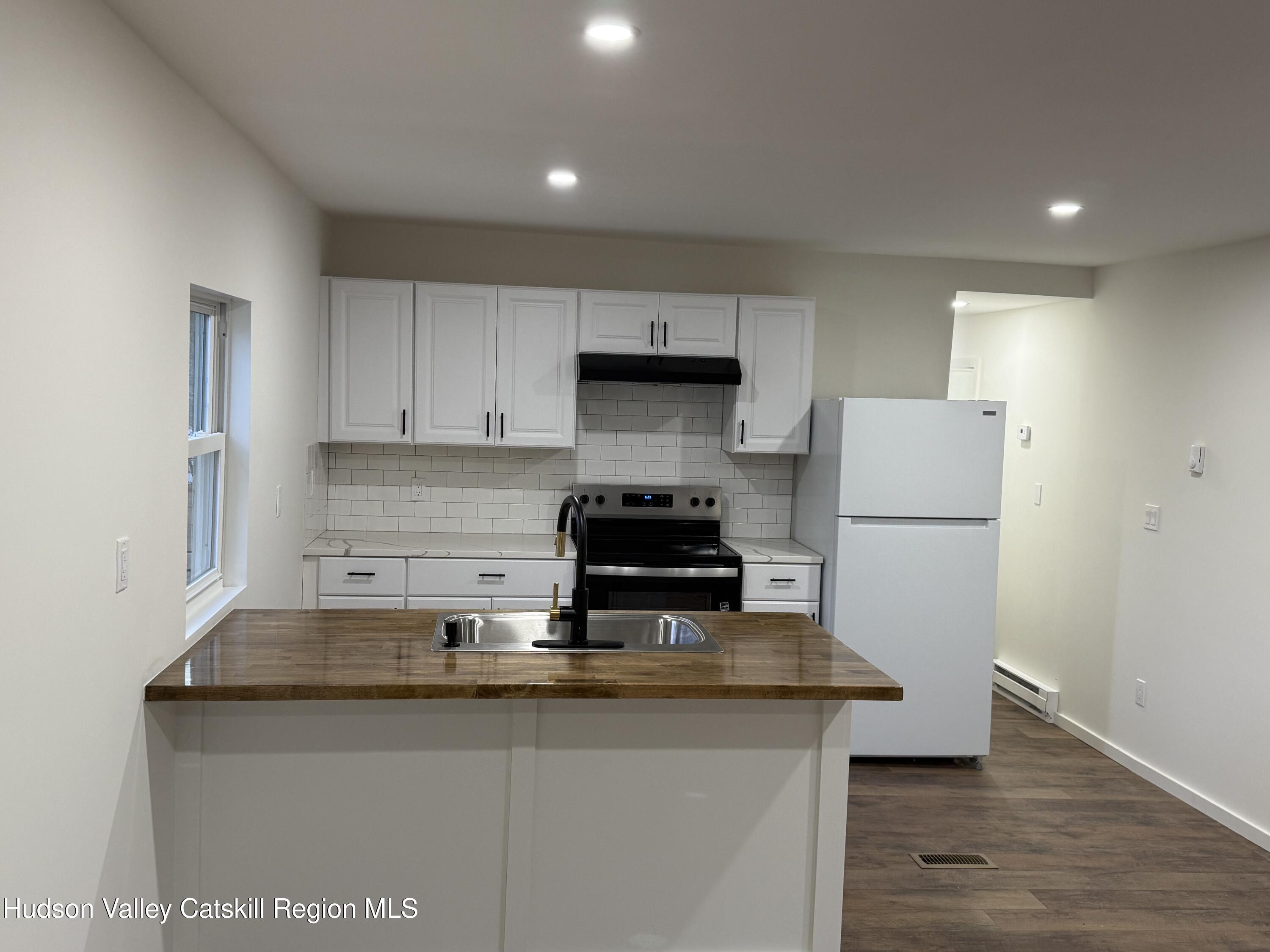 31 Bell Way Monticello, NY 12701 - Photo 6 of 15 a kitchen with a sink a stove and refrigerator