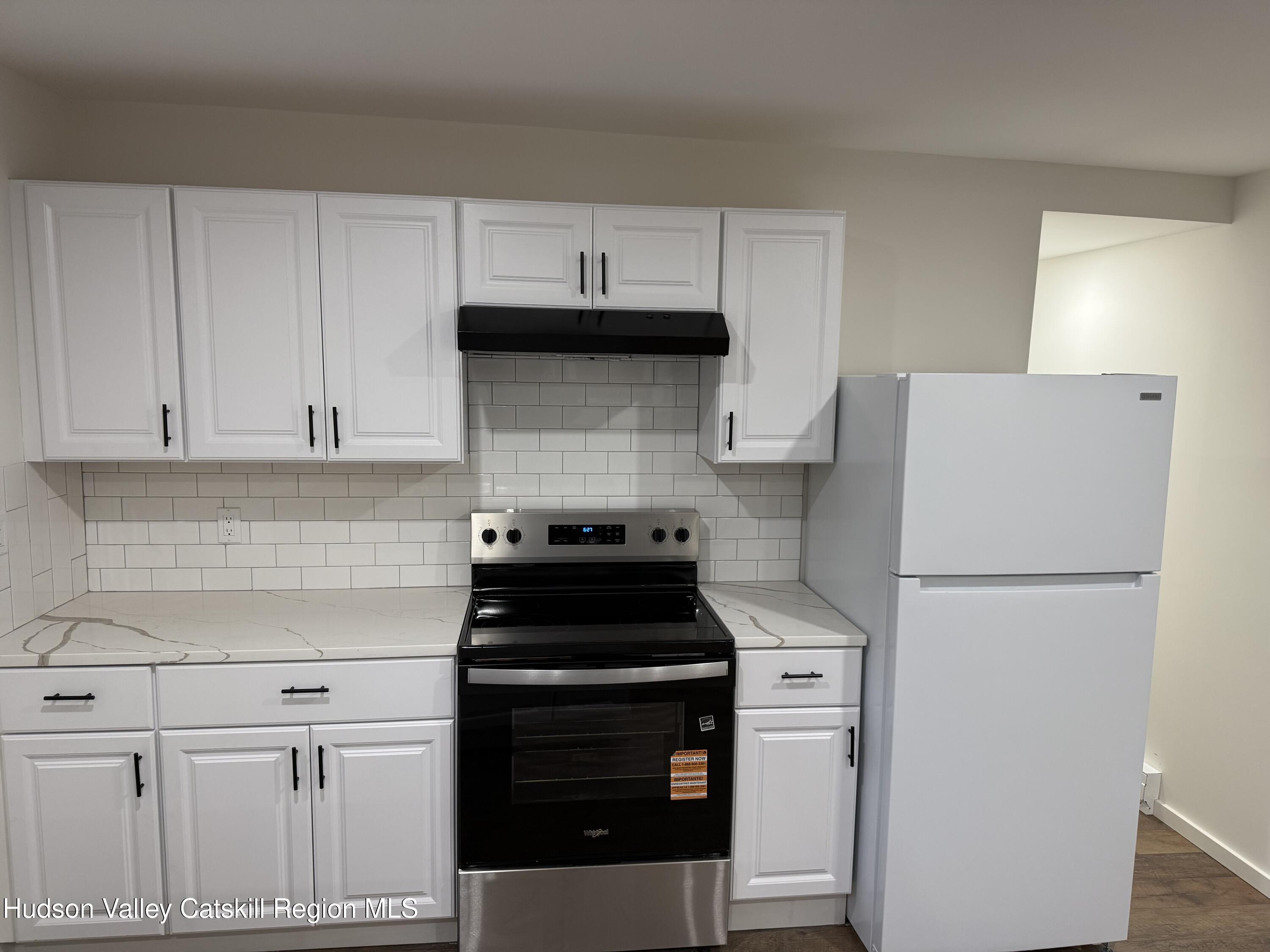 31 Bell Way Monticello, NY 12701 - Photo 7 of 15 a kitchen with a stove and a refrigerator