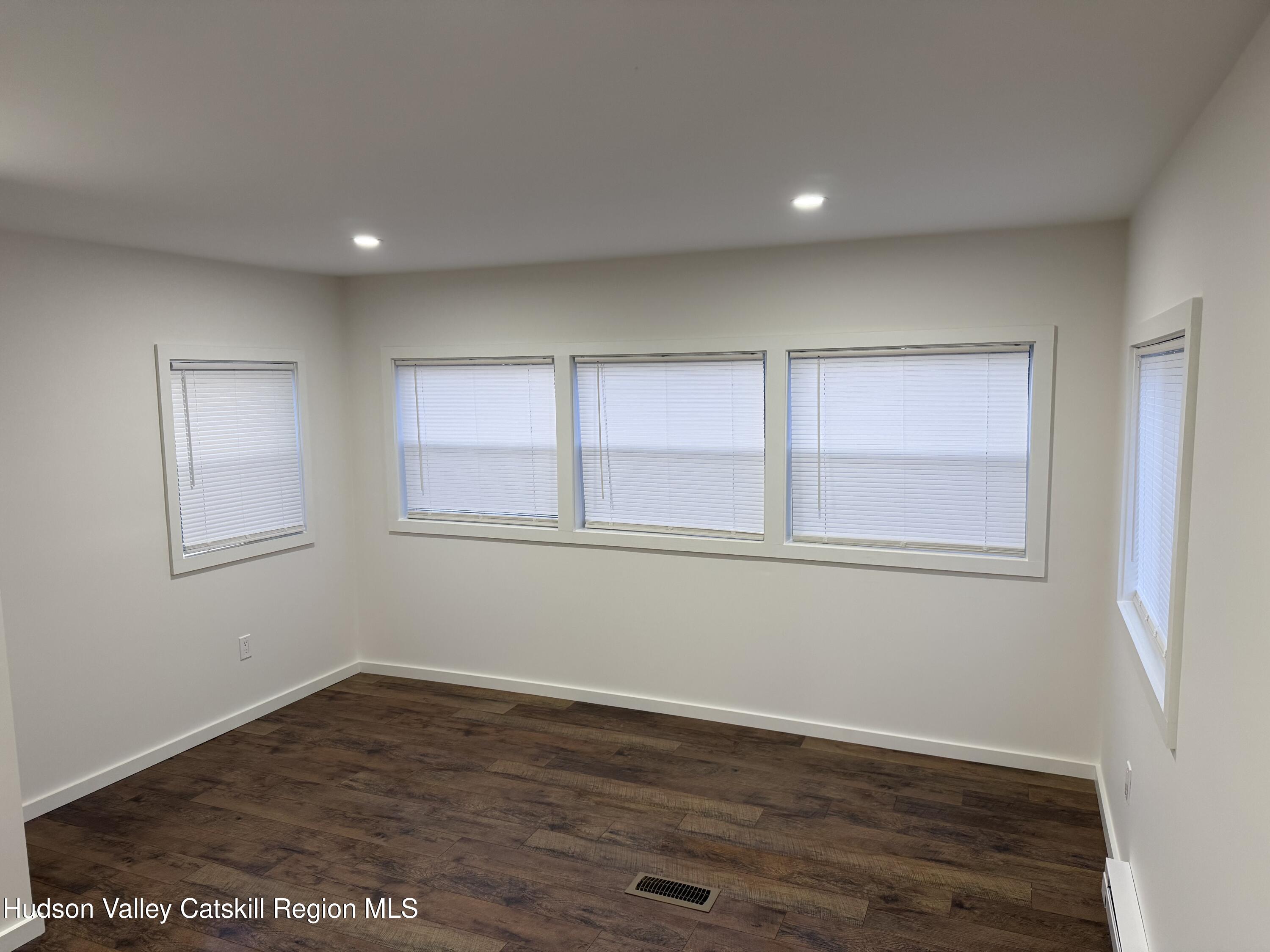 31 Bell Way Monticello, NY 12701 - Photo 10 of 15 a view of an empty room with wooden floor and window