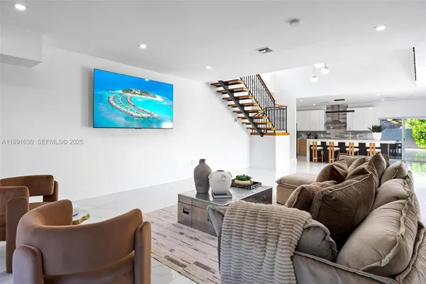 a living room with furniture and a wooden floor