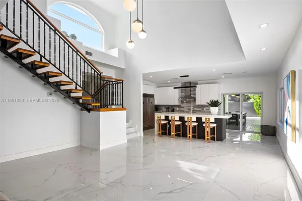 a kitchen with lots of counter space and windows