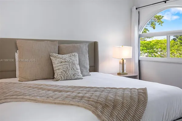 a bedroom with a bed and a wall painting