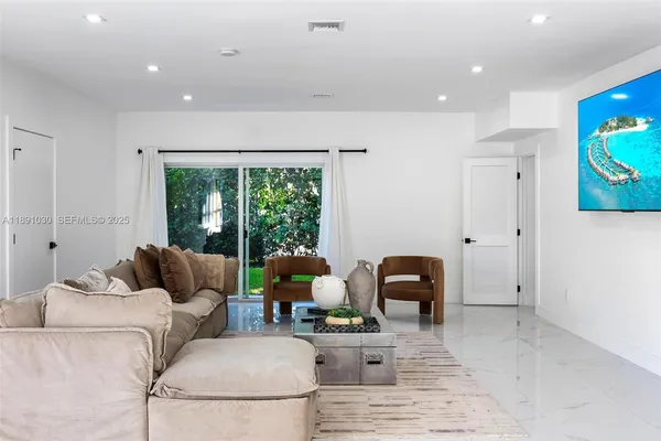 a living room with furniture and a large window